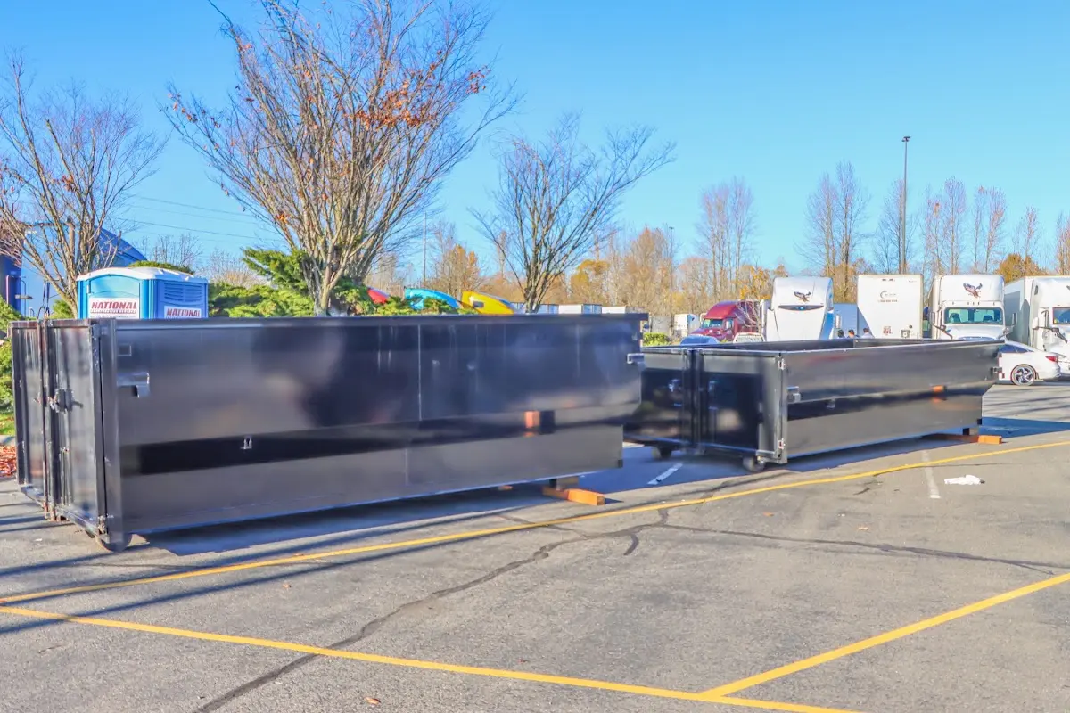 Professional dumpster rental service with roll-off container on residential driveway in Parkersburg